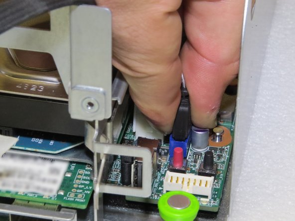 The metal tab must be depressed to disconnect the cable.