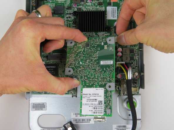 Lift the NIC to remove it from the motherboard.