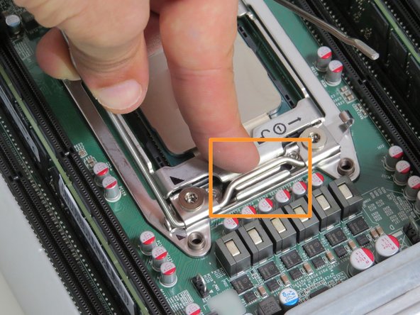 Ensure the 'lock' CPU retention lever is on top of the CPU retention gate lip, as shown.