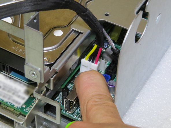 Do not push the connector too far as it may damage the hard drive power header pins.