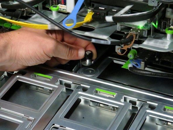 Loosen the thumbscrew.