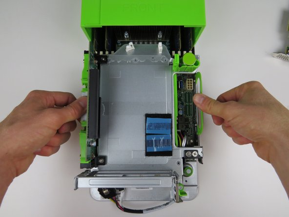 Lower the PCI Riser Cage onto the server chassis and press firmly to seat.