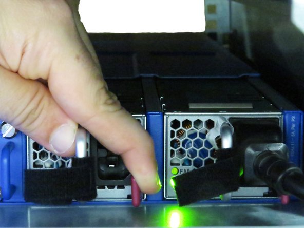 While depressed, pull the PSU towards the rear of the rack.