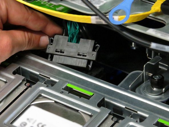 Pull the cable towards the rear until it unseats from its connector.