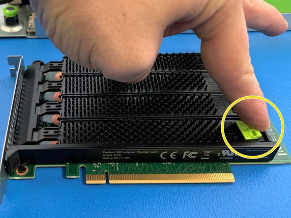 Close the cover by pulling the green tab towards the front of the card and then releasing to lock once the cover is seated.