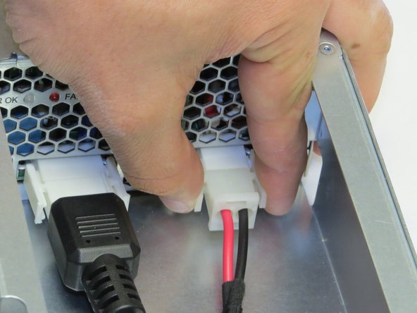 Disconnect one DC cable connector from the PSU.