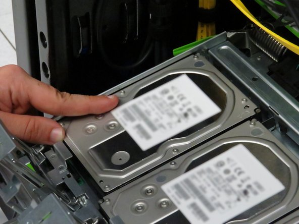 This will unseat the drives from their SATA and power connectors.