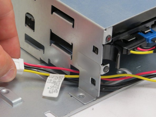 Route the new SATA / power cable through the chassis near the HDD tray.