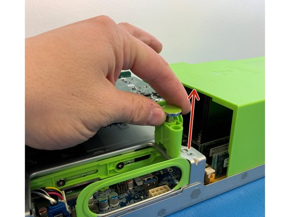 Pull the green retention plunger upwards and then turn 90 degrees clockwise to release the AVA M.2 carrier card.