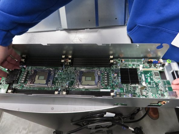 Slide the motherboard towards the rear of the chassis.