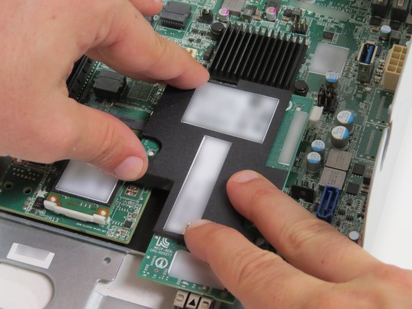 Lightly press the black film of the NIC until all (4) nylon standoffs secure the NIC to the motherboard.