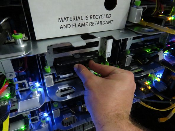 Ensure the black nylon HDD release has secured the drive, as shown.