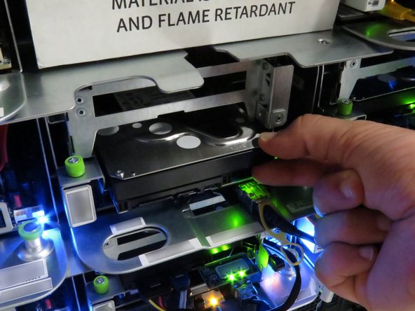 Insert your fingers right above the HDD.