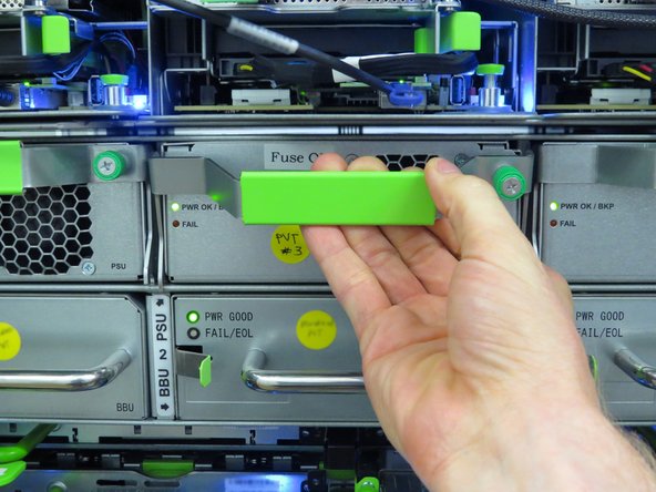 Pull the handle downward to release the PSU from the power shelf socket.