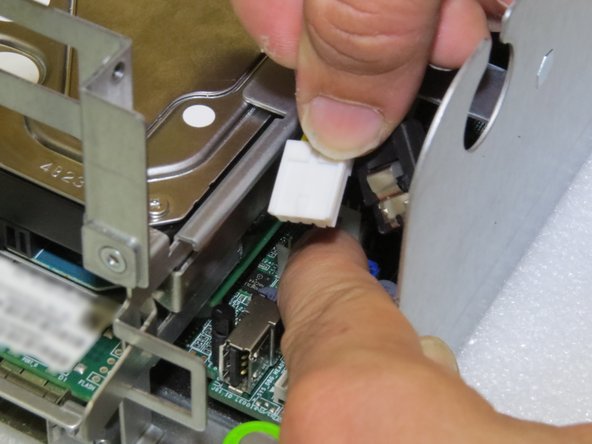 Grasp the power cable connector.