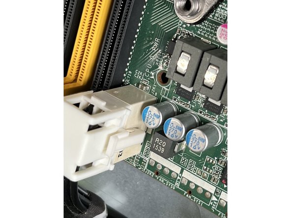Remove the two final connectors at the rear of the board by depressing the locking claps and pulling upwards