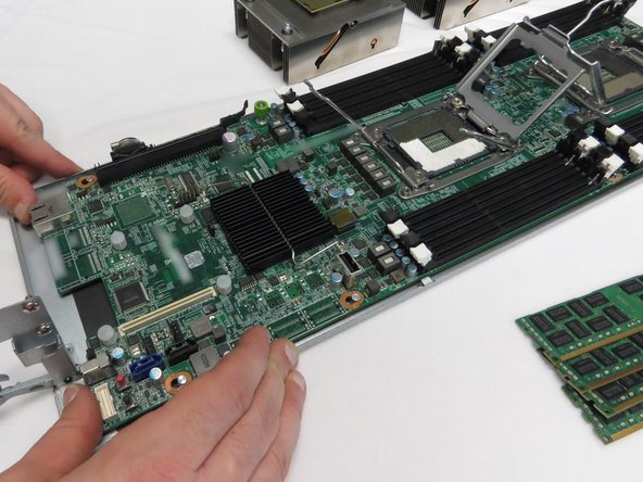 Push the motherboard towards the front of the server sled.