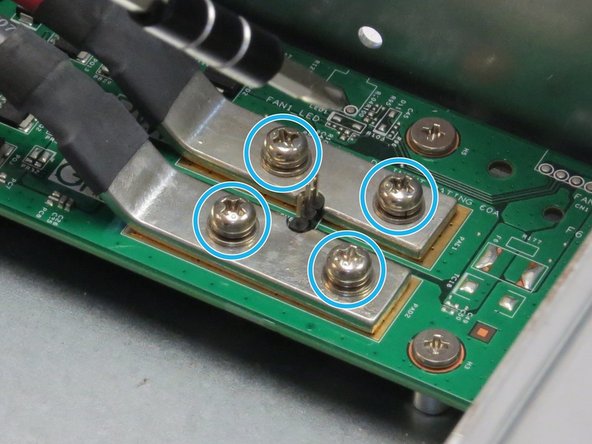 Unscrew four Phillips #2 screws that secure the bus bar leads to the fan controller board.