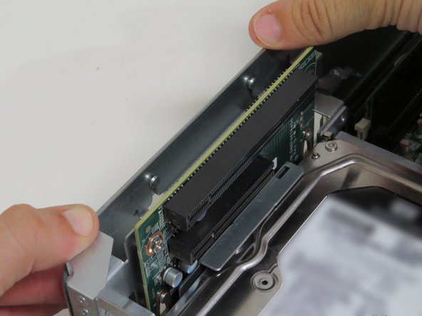Press the riser card assembly down (most near the riser card PCB) until a 'click' is felt.