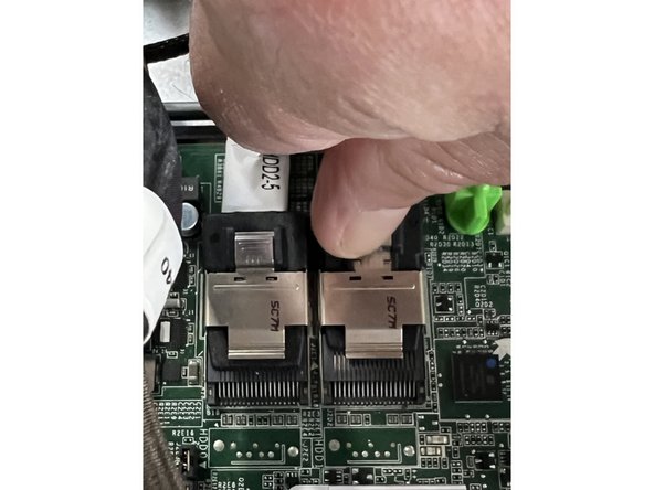 Depress the metal tab gently and slide the connector horizontally.