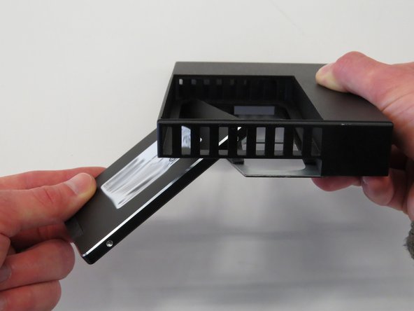 Insert a new SSD into the adapter, as shown.