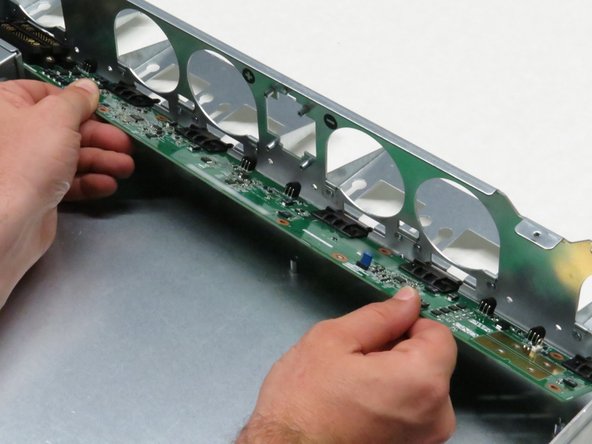 Align the chassis fan socket headers into the six chassis cutouts.