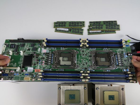 Lower the motherboard into the chassis.