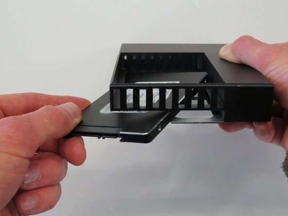 Remove the SSD from the adapter, as shown.