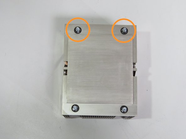 Align the rear (2) heatsink screw posts with the CPU retention post holes, as shown.