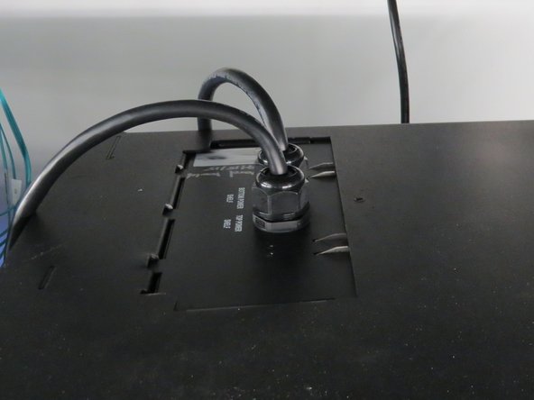 Apply upward pressure to the bottom of the PDU so that the two green latches are depressed by the roof of the rack.