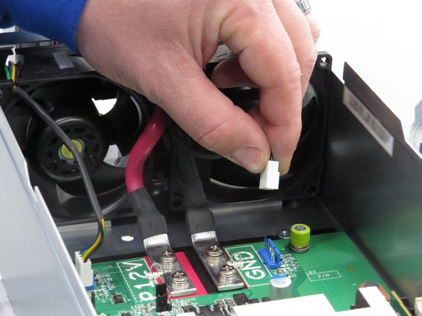 Grasp the fan power connector close to the connection header when disconnecting.