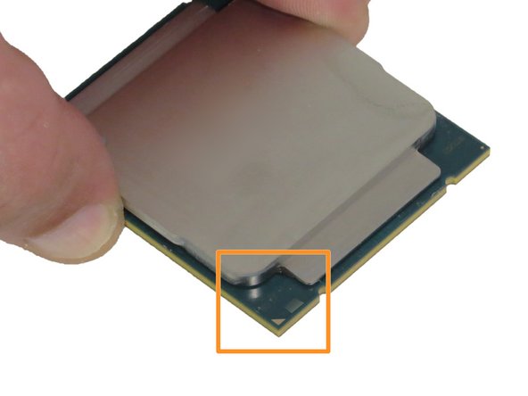 Orientate the CPU so that the arrow printed on the CPU aligns with the arrow printed on the CPU retention housing, as shown.