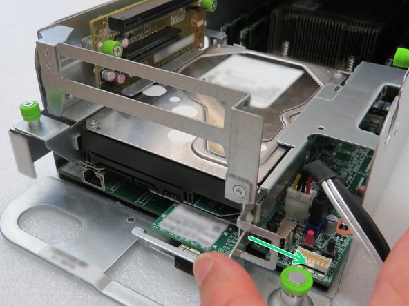 Press the hard disk drive retention bracket towards the right.