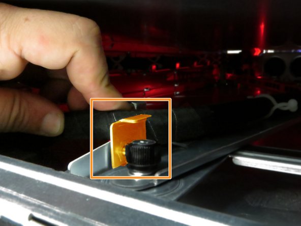 Route the Powerblade cable behind the storage tray tab.