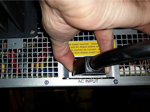 Connect the AC power cable into the corresponding blue input connector socket.