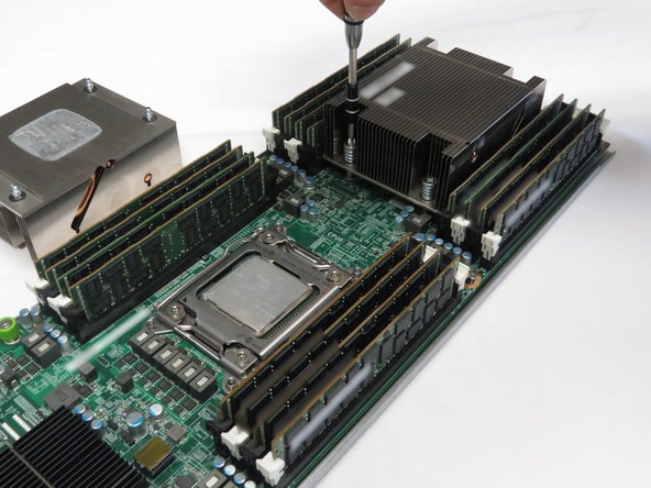 Using a cross-torque technique, loosen the Phillips #2 screws in a diagonal pattern to disconnect the CPU heatsinks from the motherboard.