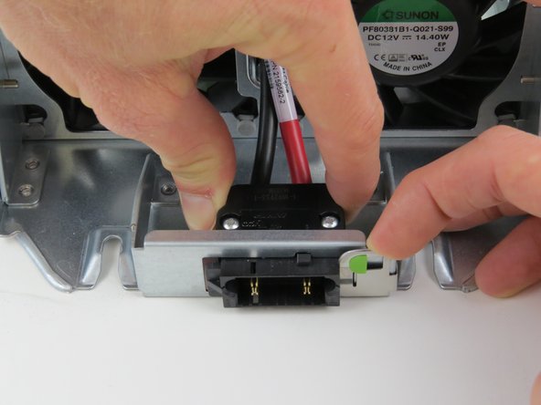 Simultaneously slide the power connector to the right to release.