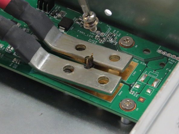 Unscrew four Phillips #2 screws that secure the bus bar leads to the fan controller board.