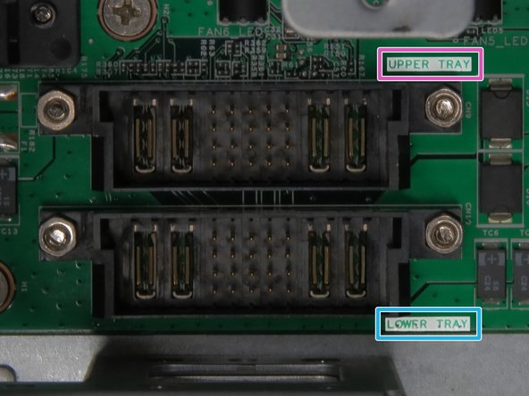 Be mindful of the orientation of the two Powerblade cables. The top-most tray Powerblade cable connects to the socket labeled UPPER TRAY. The lower tray Powerblade cable connects to the socket labeled LOWER TRAY.