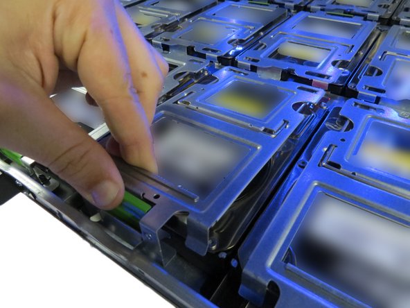 Pinch the HDD tray gate.