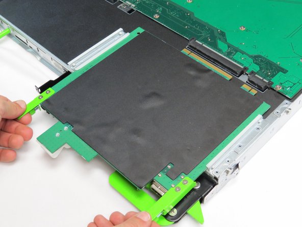 Pull the two tabs located on the front end of the expander board, as shown.