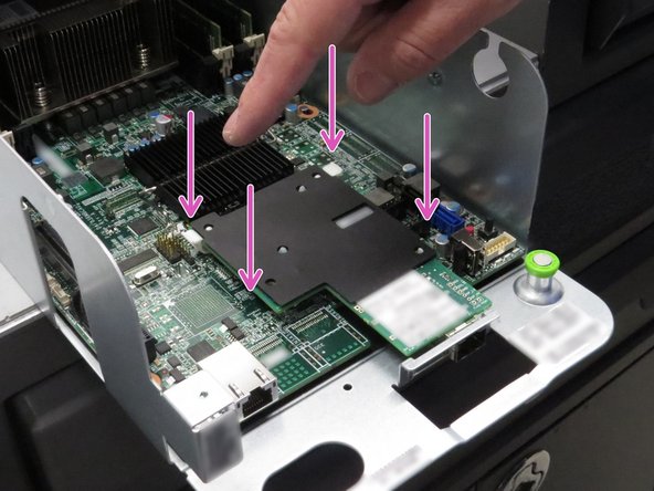 Press the four nylon NIC retention tabs downwards, as shown.