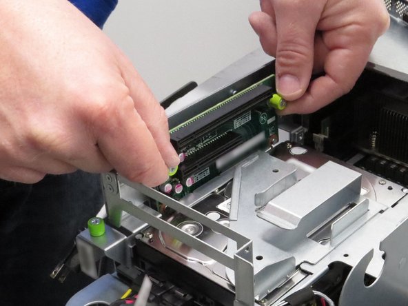 Lift the riser card away from its socket.