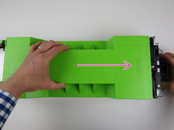 Slide it towards the rear of the chassis until it clicks into place and resistance is felt.