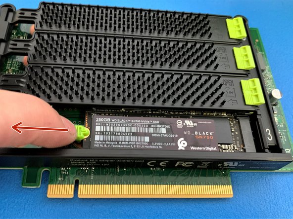 To remove NVMe SSD pull the green tab away from the SSD as shown.