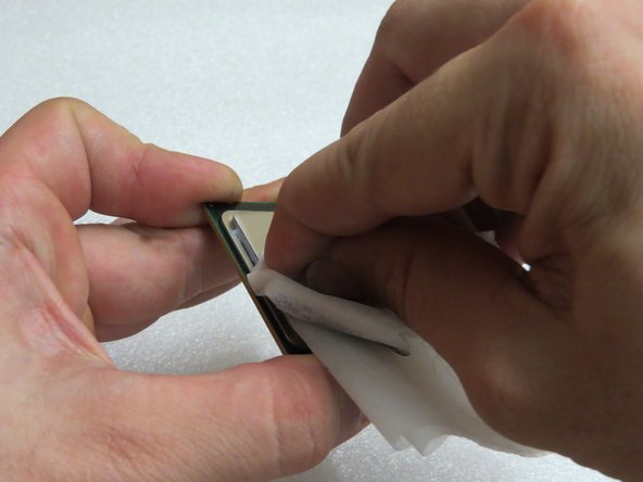 Continue wiping the CPU with the alcohol-soaked cloth to remove the thermal compound.