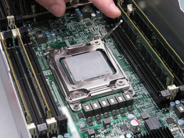 The CPU socket retention lever is spring loaded. Keep pressure on the lever as it lifts.