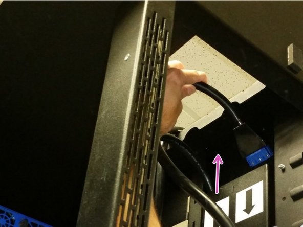 Locate the shorter AC Power cable ('TOP') and insert into the trough with the arrow pointing up.