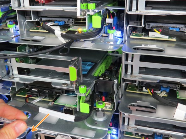 Using the handle located at the left side of the server sled, pull the sled outwards.