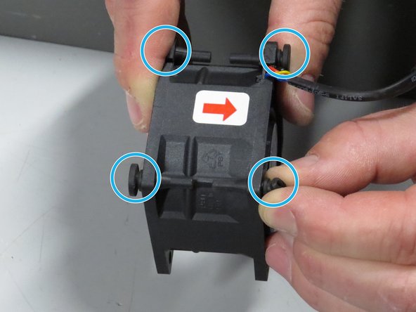 Pull the rubber grommets out from the original fan, as shown.
